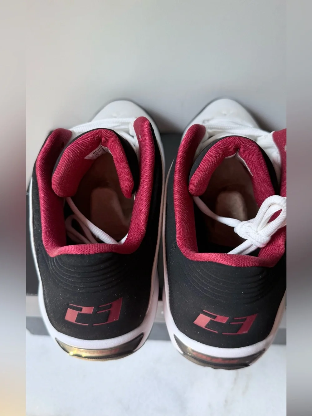 Nike Jordan Team Reign Low sneakers in a white, black, and red colorway,
